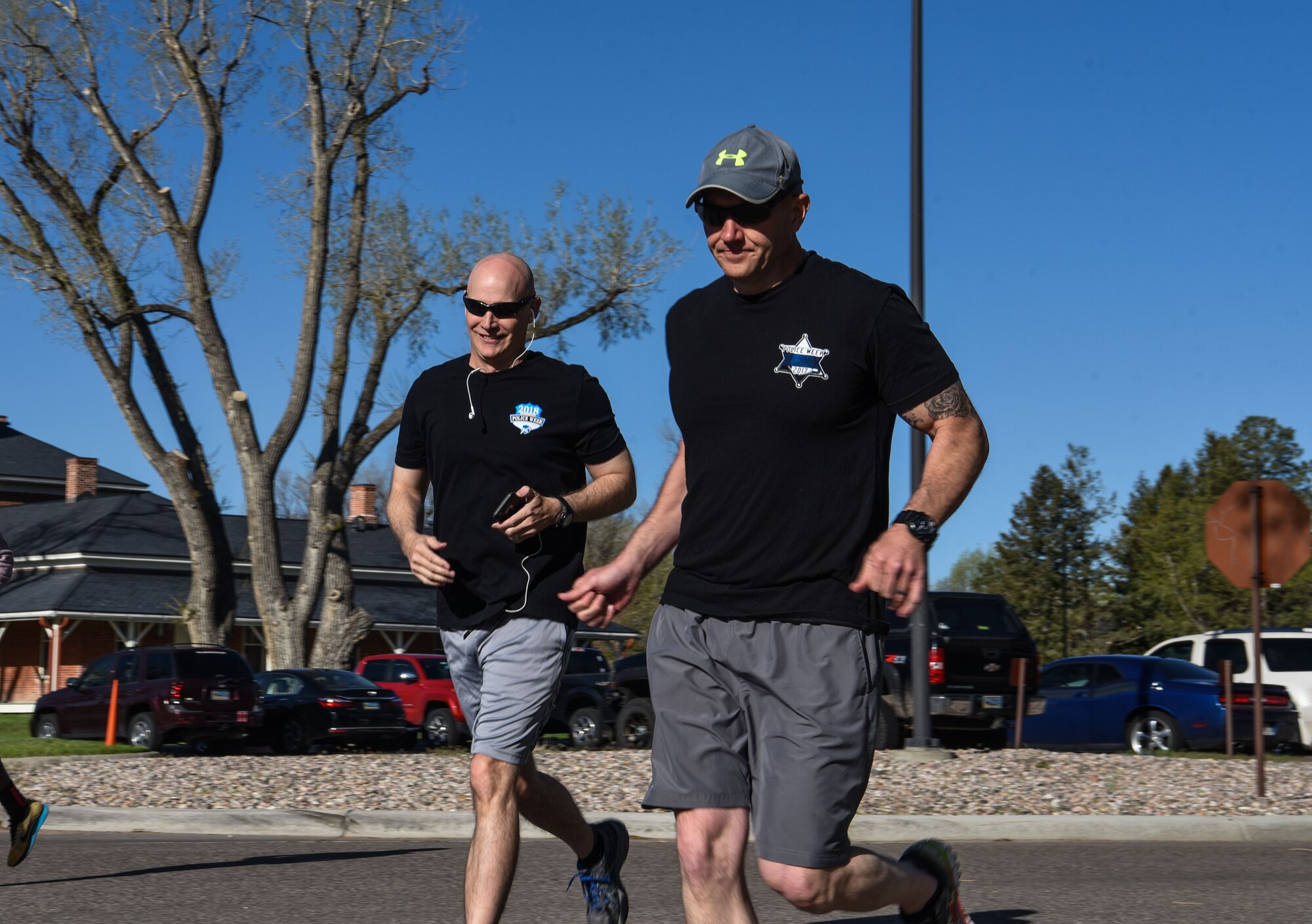 Col. John Grimm, 90th Security Forces Group commander, and Chief Master Sgt. Brian Lewis, 90th SFG chief enlisted manager, run during the Police Week 5k, May 14, 2018, on F.E. Warren Air Force Base, Wyo. More than thirty Airmen came out to support Police Week by participating in the run. In 1962, President John F. Kennedy signed a proclamation which designated May 15 as Peace Officers Memorial Day and the week in which that date falls as Police Week. People all across the United States participate in various events which honor those who have paid the ultimate sacrifice. (U.S. Air Force photo by Airman 1st Class Braydon Williams)