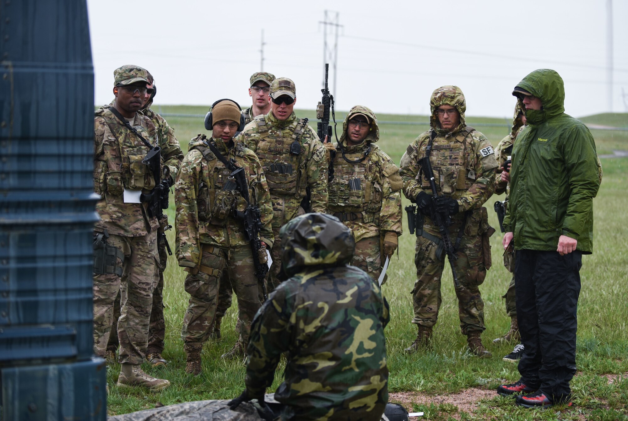 90th Missile Wing Defenders stand and listen to the competition rules during a three-gun competition for Police Week, May 19, 2018, at the Cheyenne Police Department firing range in Laramie County, Wyo. A three-gun competition consists of a set of courses in which you shoot three different weapons—a rifle, a pistol and a shotgun—at different stages, and engage various short- and long-distance targets from multiple positions. Scoring is based on time and hits minus penalties, with each stage assigned match points based on a degree of difficulty. In 1962, President John F. Kennedy signed a proclamation which designated May 15 as Peace Officers Memorial Day and the week in which that date falls as Police Week. People all across the United States participate in various events which honor those who have paid the ultimate sacrifice. (U.S. Air Force photo by Airman 1st Class Braydon Williams)