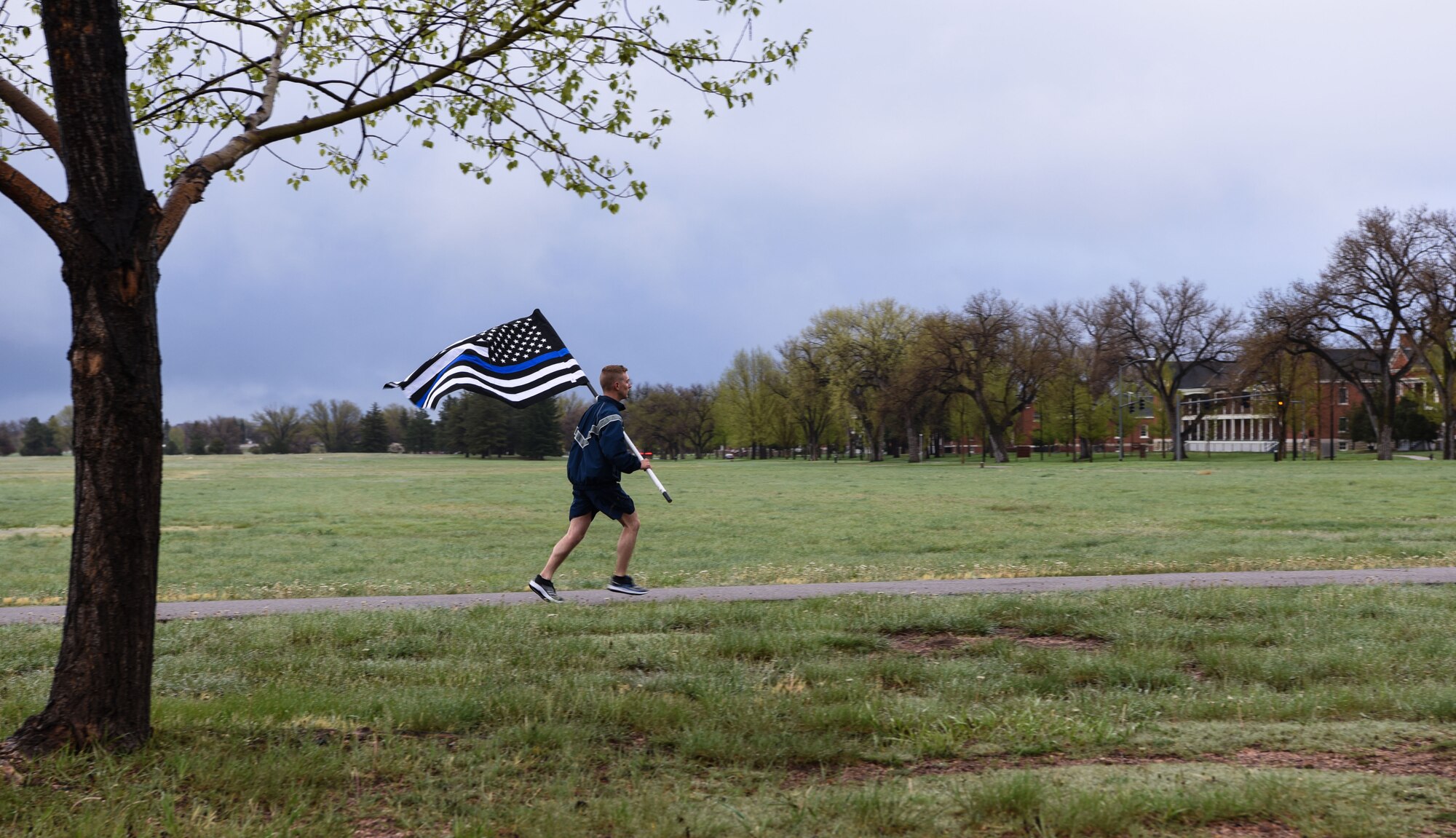 1st Lt. Justin Fitzwater, 90th Security Support Squadron defender, runs with the thin blue line flag during a twenty-four-hour remembrance run for Police Week May 13, 2018, on F.E. Warren Air Force Base, Wyo. The run was held to honor Defenders and civilian police alike who have paid the ultimate sacrifice. Various people from around base came to support the run and keep it going for the full 24 hours. In 1962, President John F. Kennedy signed a proclamation which designated May 15 as Peace Officers Memorial Day and the week in which that date falls as Police Week. People all across the United States participate in various events which honor those who have paid the ultimate sacrifice. (U.S. Air Force photo by Airman 1st Class Braydon Williams)