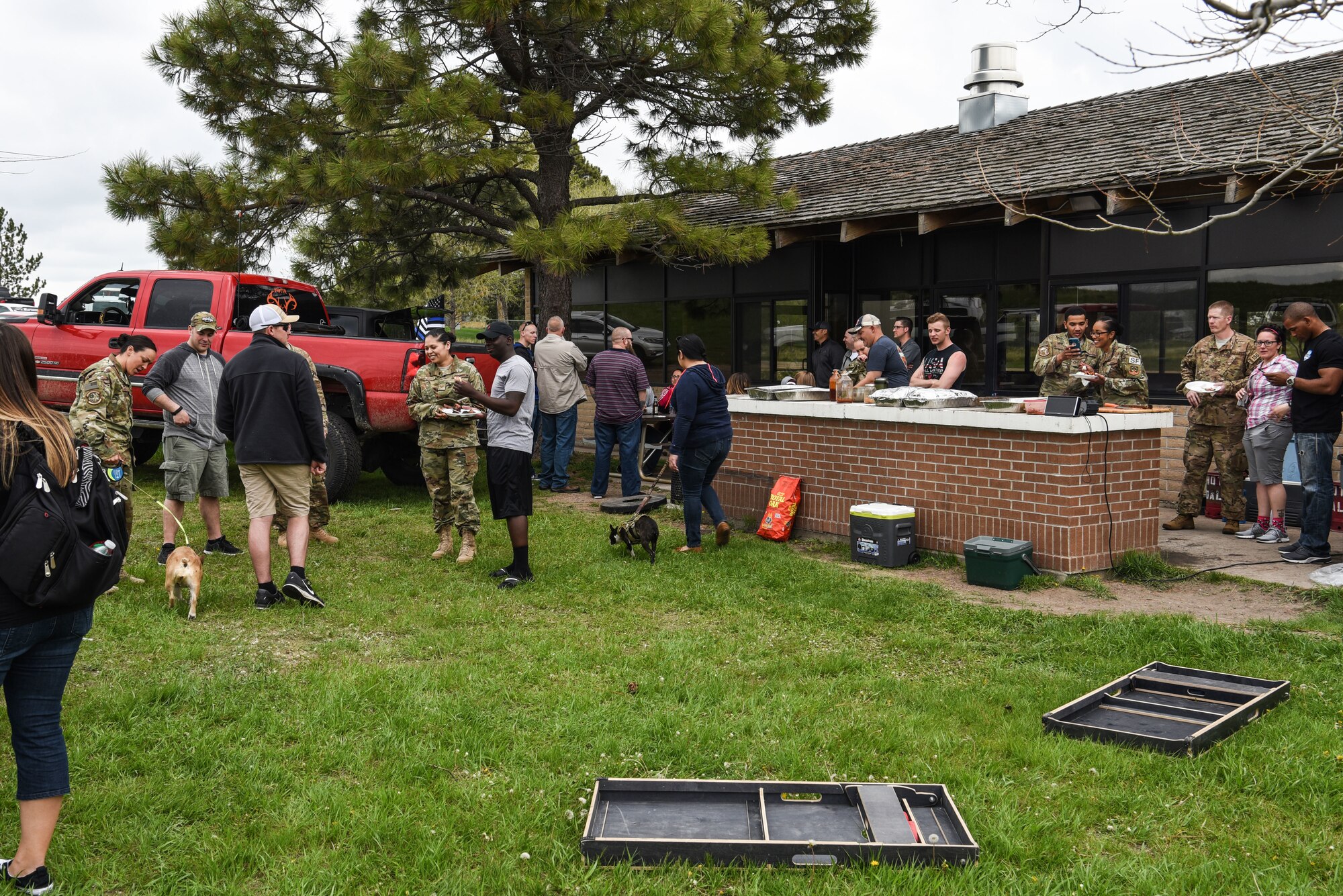 90th Missile Wing Airmen and their families enjoy a barbecue for the closing of Police Week, May 18, 2018, on F.E. Warren Air Force Base, Wyo. Police Week concluded with a festivities for Airmen and families to unwind after a week of events and work. In 1962, President John F. Kennedy signed a proclamation which designated May 15 as Peace Officers Memorial Day and the week in which that date falls as Police Week. People all across the United States participate in various events which honor those who have paid the ultimate sacrifice. (U.S. Air Force photo by Airman 1st Class Braydon Williams)