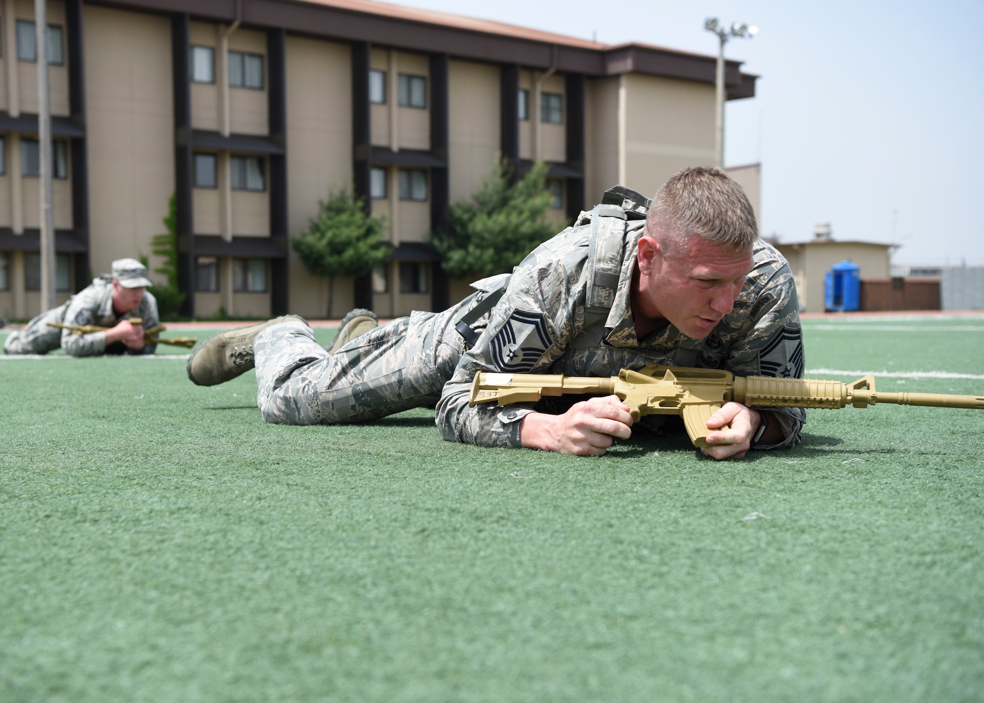 A security forces team performs a high crawl during a relay race at Osan Air Base, Republic of Korea, May 15, 2018. The relay race was hosted by the 51st Security Forces Squadron and was a part of the National Police Week 2018 events. The relay consisted of teams of performing various physical activities that mirror those of security forces training. (U.S. Air Force photo by Airman 1st Class Ilyana A. Escalona)