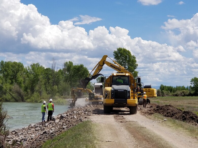 USACE Walla Walla District engineer Andy Rajala (left) and Kent Bernard, a USACE contracting specialist (right), monitor contractors' emergency repair work, May 20, on an eroded area of the Heise-Roberts Levee System on the Snake River near Lorenzo, Idaho. As of Sunday afternoon (May 20), contractors have repaired about two-thirds of the 300-feet-long by 15-feet-wide section of levee eroded away by seasonal high flows in the Snake River. In some locations the levee has been eroded more than 20 feet in height from the top of the levee -- about 8 feet of the levee is visible above the water’s surface.