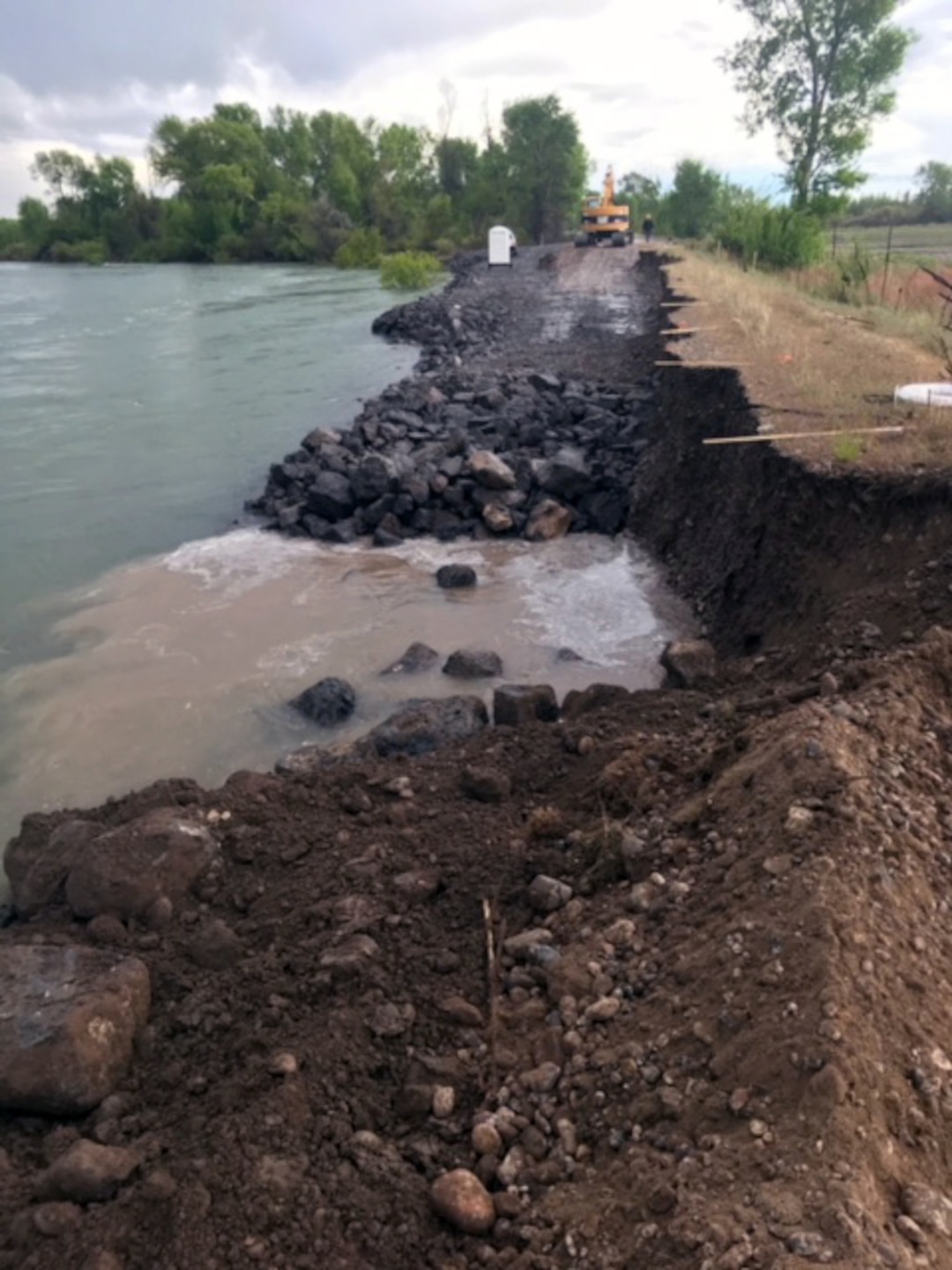 The Corps awarded the emergency repair contract May 18 to help Jefferson County emergency managers and Flood Control District #1 stabilize an eroded area of the Heise-Roberts Levee System on the Snake River near Lorenzo, Idaho. As of Monday morning (May 21), contractors have repaired more than two-thirds of the 300-feet-long by 15-feet-wide section of levee that was eroded away by seasonal high flows in the Snake River. In some locations the levee has been eroded more than 20 feet in height from the top of the levee -- about 8 feet of the levee is visible above the water’s surface. If not repaired, the erosion poses a threat to the structural integrity of the levee and about 65 homes located within the leveed area.