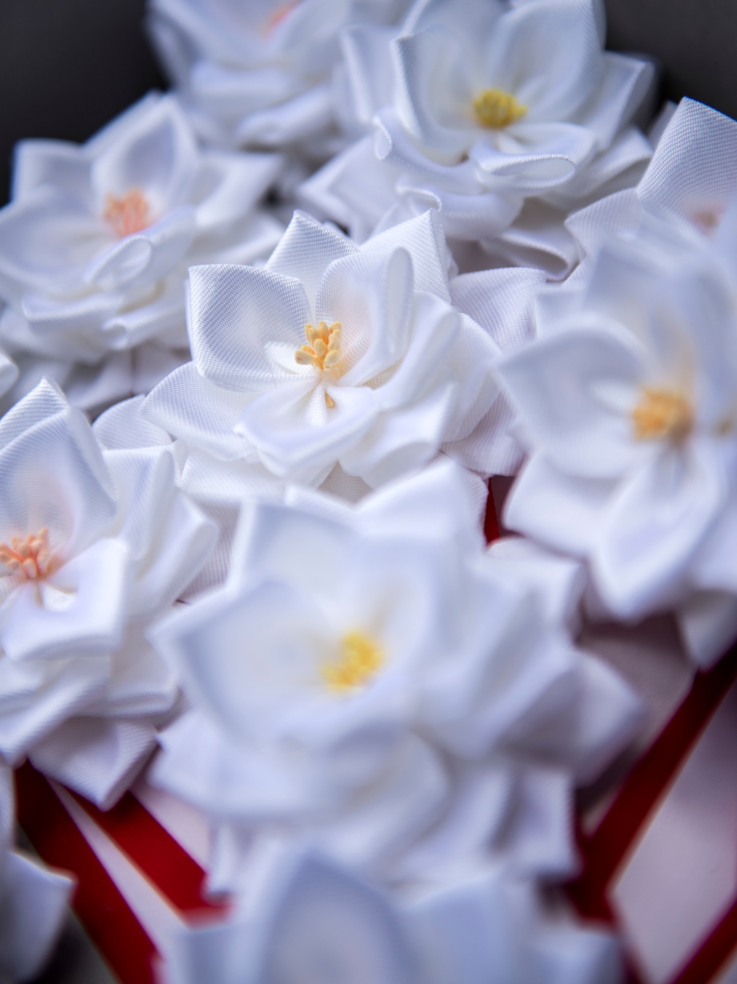 Good Deed Award white floral ribbons displayed on table
