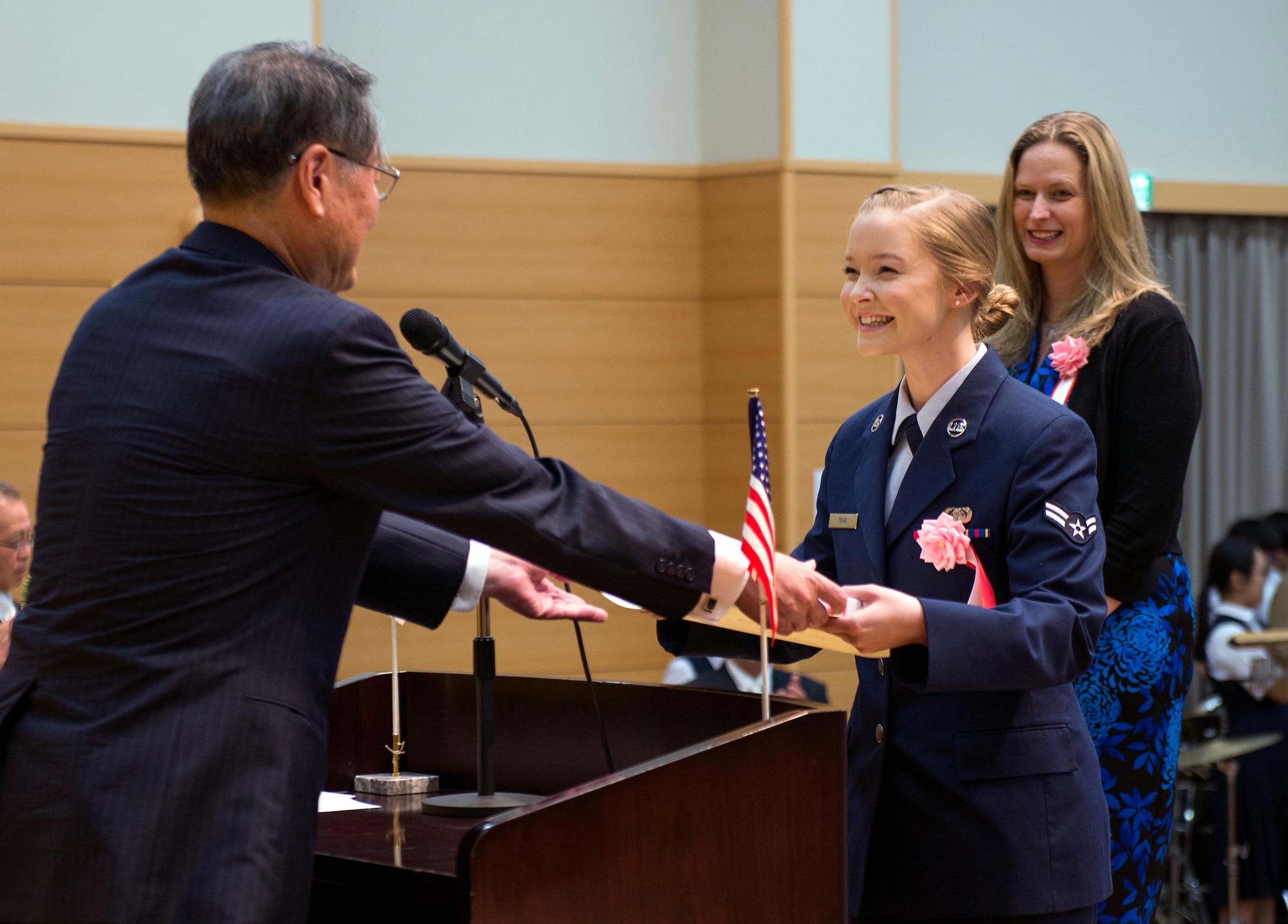 Airman 1st Class Ashlyn M. Tran, 374th Communications Squadron cyber systems technician, receives an award