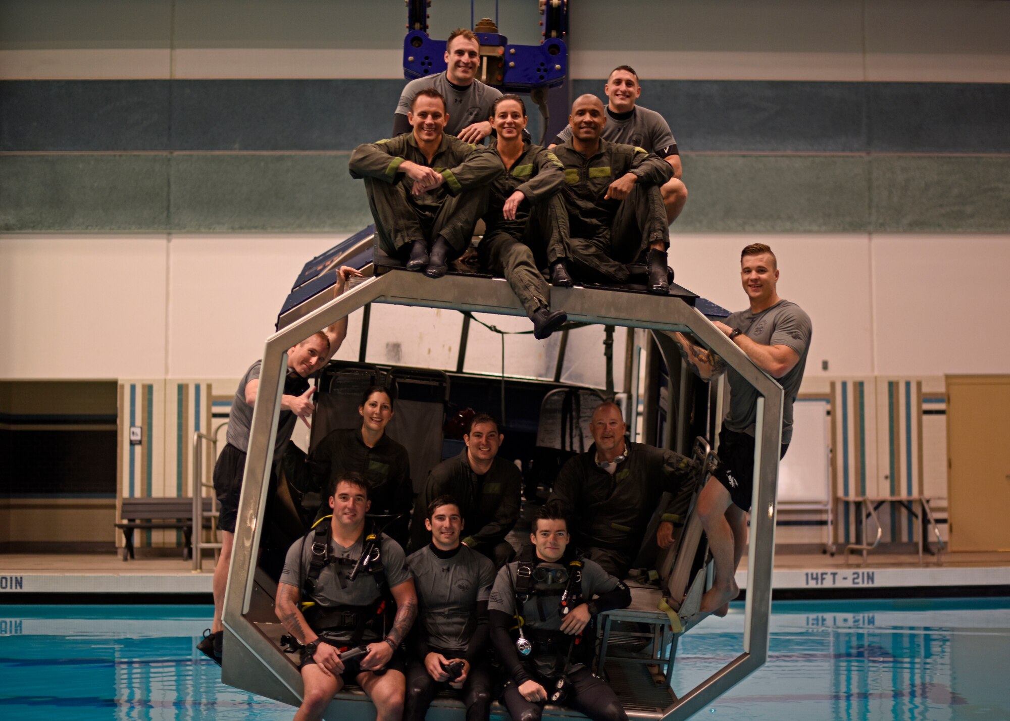 The NASA team and Survival, Evasion, Resistance and Escape specialist pose for a photo after completing the water survival course at Fairchild Air Force Base, Washington, May 18, 2018. The NASA team completed the dunker course. Trainees are strapped inside a modular egress training system that simulates a mock helicopter with lap belts that submerges into water and rotates to teach aircrew how to find their exits to safety. (U.S. Air Force photo/Airman 1st Class Jesenia Landaverde)