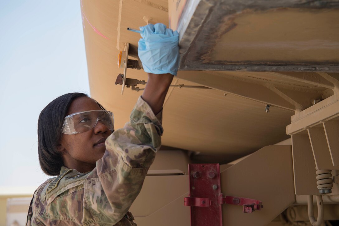 Staff Sgt. Brittany Long, 386th Expeditionary Maintenance Squadron nondestructive inspection craftsman, demonstrates how to complete an inspection at an undisclosed location in Southwest Asia, May 14, 2018. NDI identifies cracks in the weld to ensure it does not have to be re-accomplished. (U.S. Air Force photo by Staff Sgt. Joshua King)