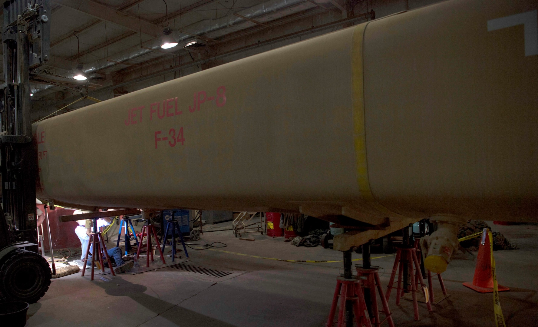 A 6,000 gallon fuel tank is repaired at an undisclosed location in Southwest Asia, April 27, 2018. The tank began to leak recently and needed the cracks to be sealed. (U.S. Air Force photo by Staff Sgt. Joshua King)