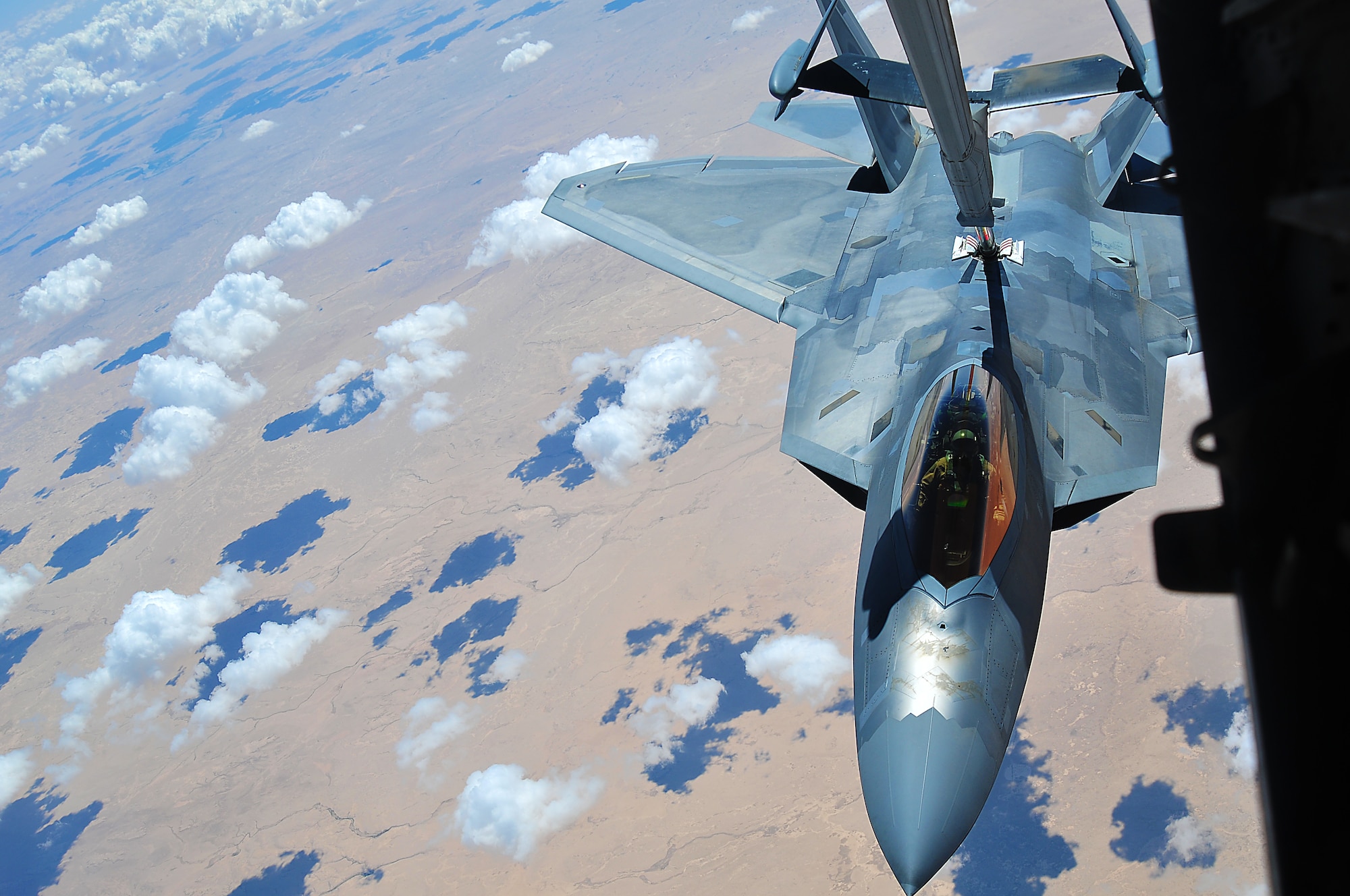 A 94th Fighter Squadron F-22 Raptor at the 380th Air Expeditionary Wing, Al Dhafra Air Base refuels mid-air by a 908th Air Refueling Squadron KC-10 Extender, May 16, 2018.  Air refueling is a vital component of flying operations, allowing the F-22 to stay airborne longer and support U.S. and coalition forces in the air and on the ground as a part of Operation Inherent Resolve.