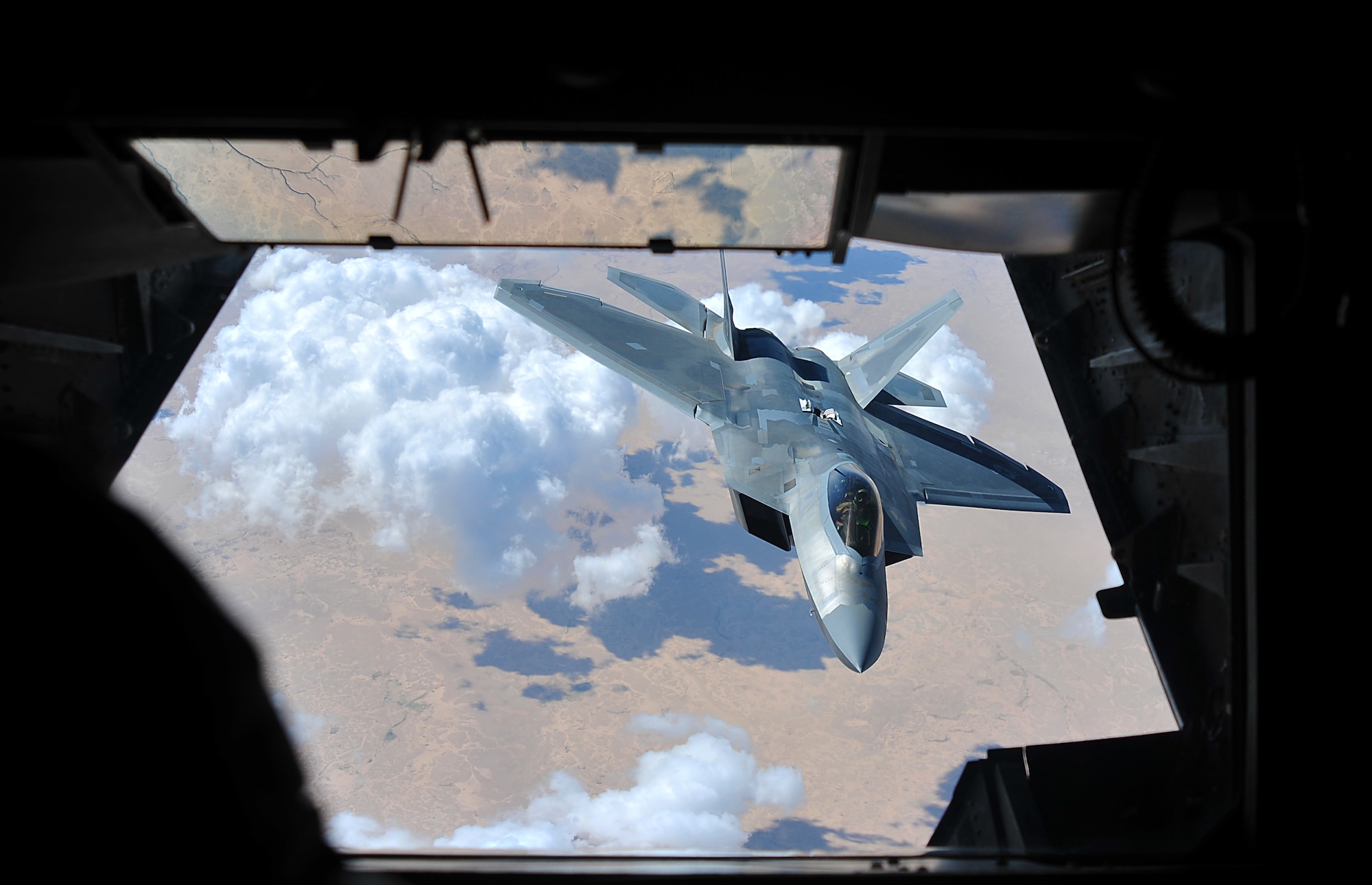 A F-22 Raptor assigned to the 94th Fighter Squadron at the 380th Air Expeditionary Wing, Al Dhafra Air Base descends from a 908th Air Refueling Squadron KC-10 Extender refueling aircraft during a flying mission over Southwest Asia, May 16, 2018. The Raptor’s mission is to help ensure that the operations of U.S. and coalition forces on the ground and in the air are unimpeded by adversary aircraft as a part of Operation Inherent Resolve.