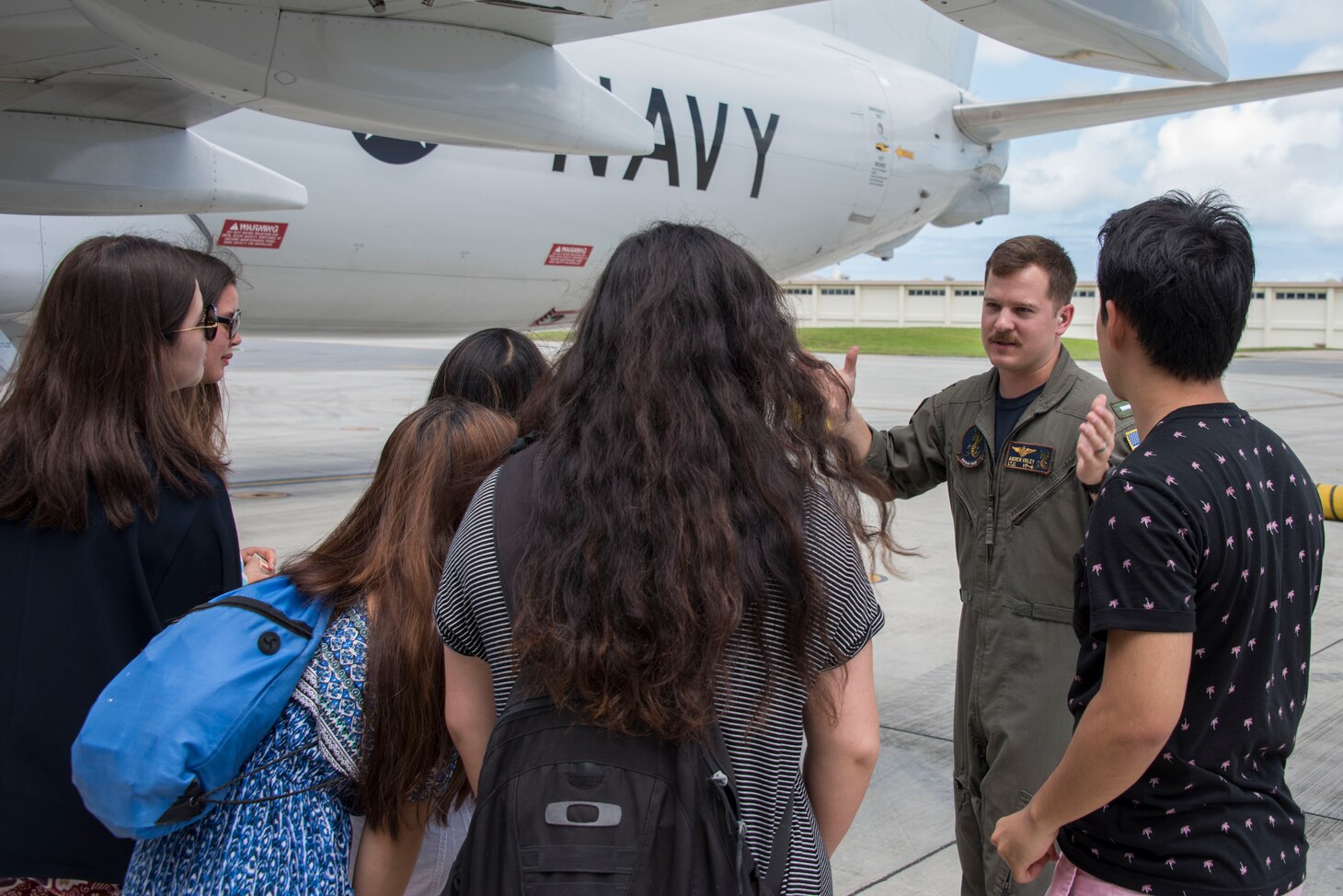 Lt. j.g. Anderew Kriley, from Pittsburgh, Pa., assigned to the "Skinny Dragons" of Patrol Squadron (VP) 4, gives a tour of a P-8A Poseidon aircraft to students from the American School in Japan. The students were in Okinawa to learn about the U.S. Navy’s and the Japan Maritime Self-Defense Force’s (JMSDF) roles, capabilities and missions.