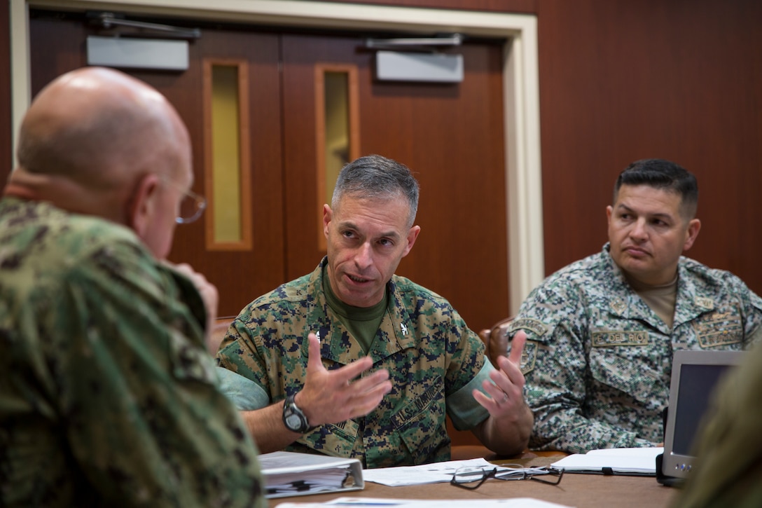 U.S. Marine Col. Michael Oppenheim, the commander of Special Purpose Marine Air-Ground Task Force - Southern Command, center, and Colombian Naval Infantry Lt. Col. Erick H. Del Rio, the SPMAGTF-SC deputy commander, right, talk to U.S. Navy Adm. Kurt W. Tidd, the commander of U.S. Southern Command, about the upcoming deployment of the MAGTF to Latin America during a confirmation brief in Doral, Florida, May 16, 2018. The Marines and sailors of SPMAGTF-SC will soon deploy to conduct security cooperation training and engineering projects alongside partner nation military forces in Central and South America. The unit will also be on standby to provide humanitarian assistance and disaster relief in the event of a hurricane or other emergency in the region.