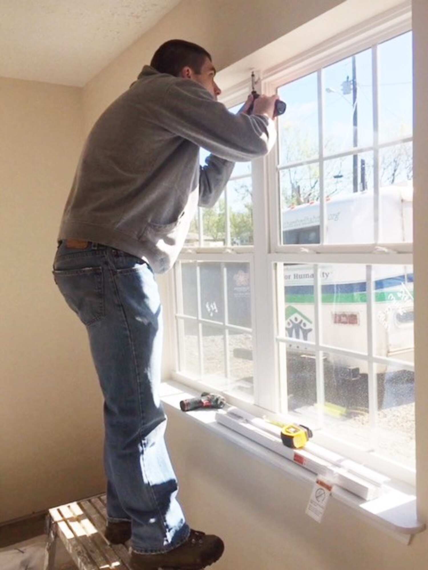 1st Lt. Adam McKenzie, a member of the Arnold Air Force Base Company Grade Officer Council, installs clips for hanging blinds. Members of the CGOC recently volunteered with Rutherford County Area Habitat for Humanity and worked on two homes the Habitat is constructing in the area.