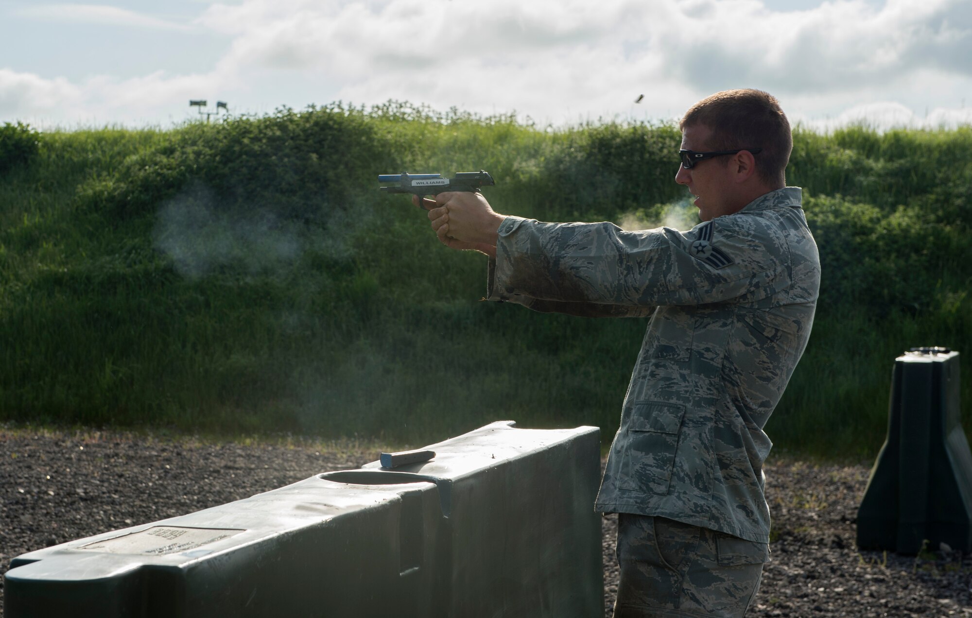 U.S. Air Force Senior Airman Clark, 422nd Security Forces Squadron, fires a hand gun at RAF Croughton, May 18, 2018. The operator fired simulation rounds at a target as part of the 2018 Police week relay race. (U.S. Air Force photo by Senior Airman Chase Sousa)