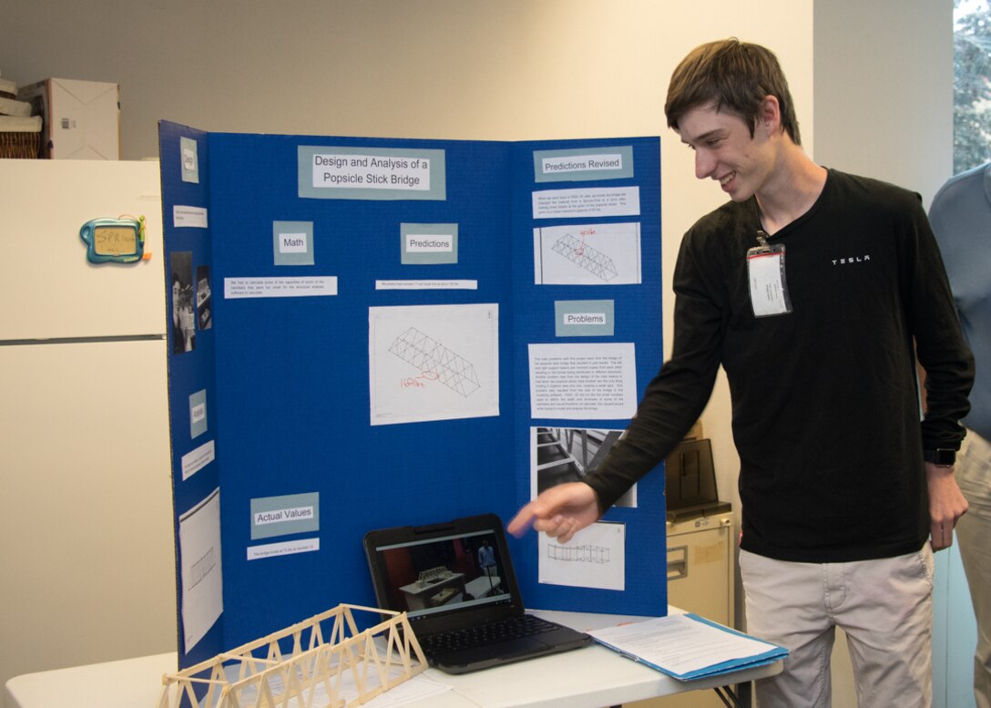 Local high school junior concludes his spring semester Gifted Independent Study Class at the Middle East District's Engineering Division, with a presentation on his project. He built a popsicle stick bridge and using available engineering analysis software, calculated the weight-bearing capacity before testing the bridge.