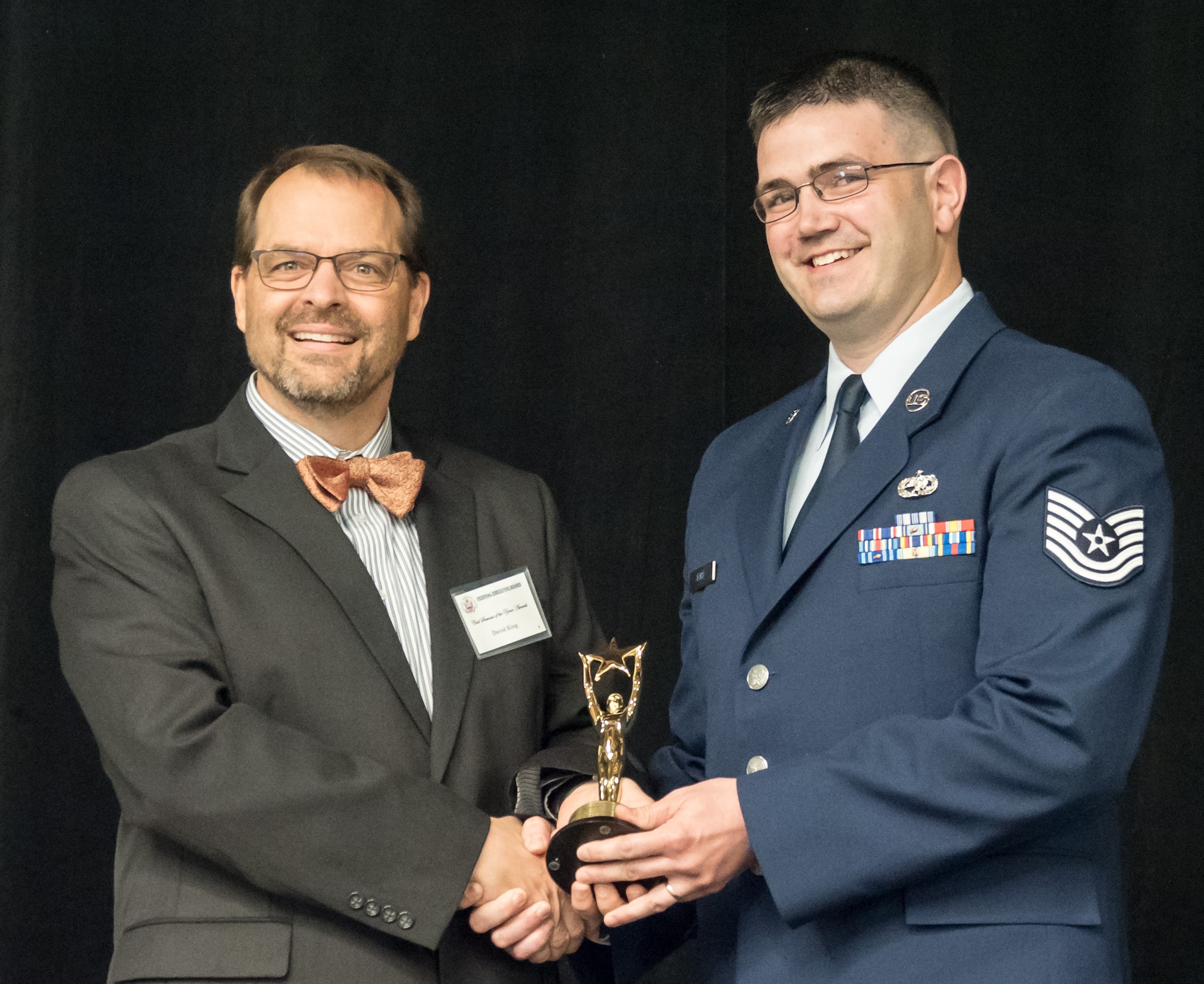 Tech. Sgt. Matthew Fors accepts the Innovation Award for all Minnesota Federal agencies at the Federal Executive Board Civil Servant of the Year ceremony May 8, 2018. (Air Force Photo/Paul Zadach)