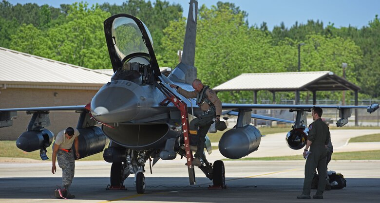 Upon landing, U.S. Air Force Lt. Col. James Buessing, 77th Fighter Squadron commander, gathered his things to greet his family for the first time in six months at Shaw Air Force Base, S.C., May 4, 2018.