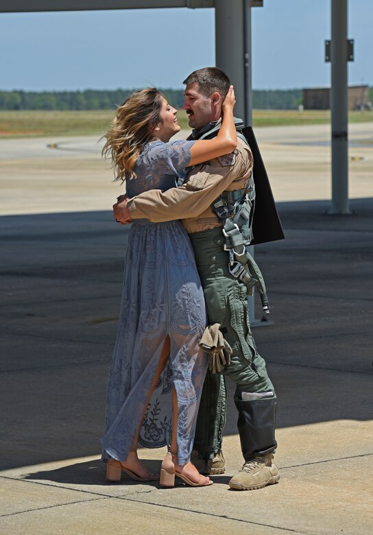 An F-16CM Fighting Falcon pilot assigned to the 77th Fighter Squadron, greets his wife upon returning home from Afghanistan to Shaw Air Force Base, S.C., May 4, 2018.