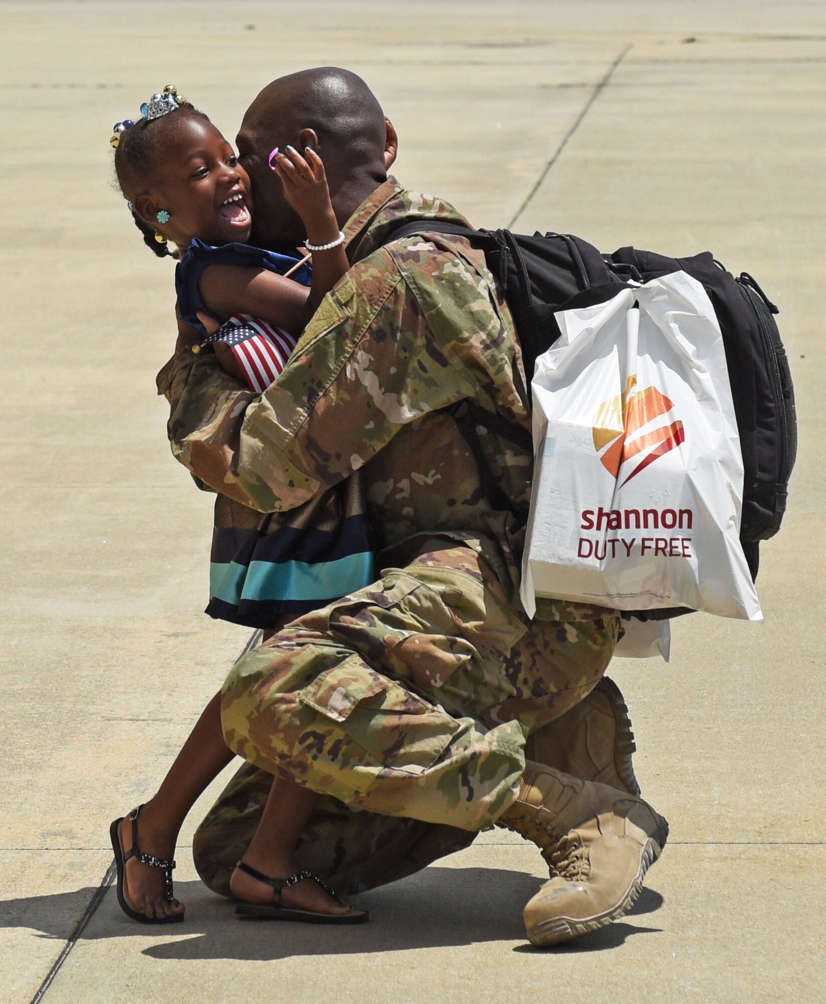 U.S. Air Force Senior Master Sgt. Larry Tate, 20th Aircraft Maintenance Squadron assistant superintendent, embraces his daughter upon return from a six-month deployment at Shaw Air Force Base, S.C., May 6, 2018.