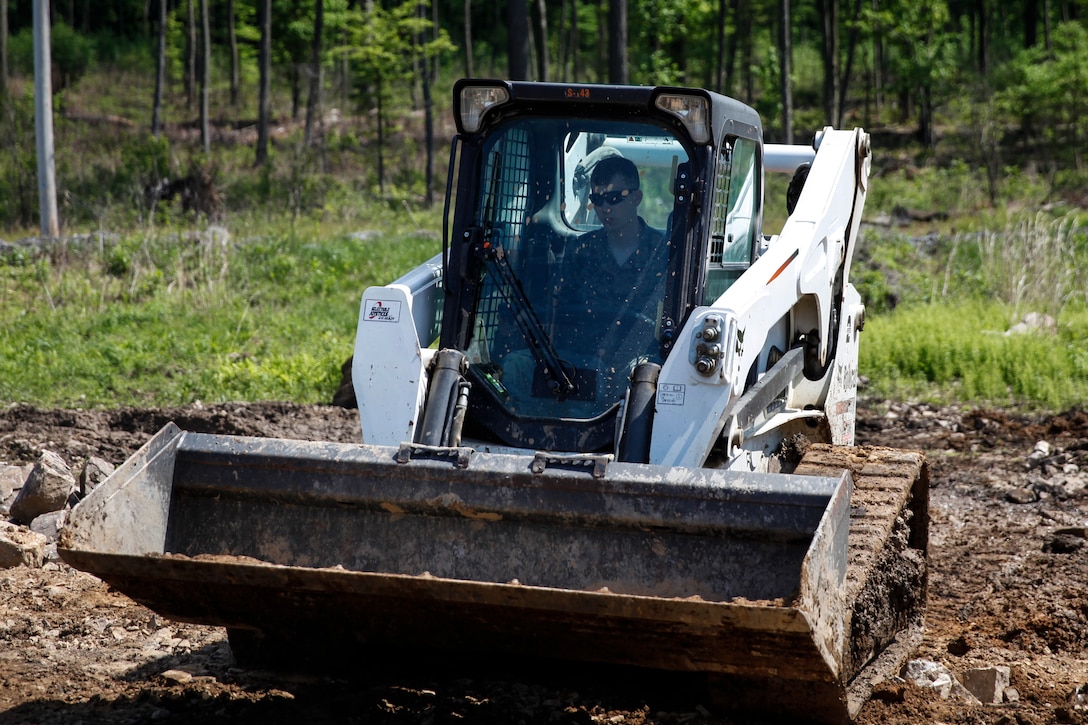 U.S. Marine Lance Cpl. Mitchell R. Neimann, heavy equipment operator with Engineer Company C, 6th Engineer Support Battalion, 4th Marine Logistics Group, operates a Bobcat bulldozer to level out the ground at a construction site during exercise Red Dagger at Fort Indiantown Gap, Pa., May 21, 2018.