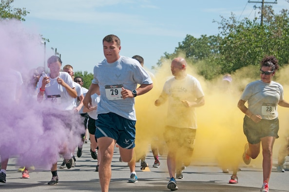 Participants run through vibrant clouds of powder during the 919th Special Operations Wing's first-ever Color Run May 5, 2018 at Duke Field, Fla