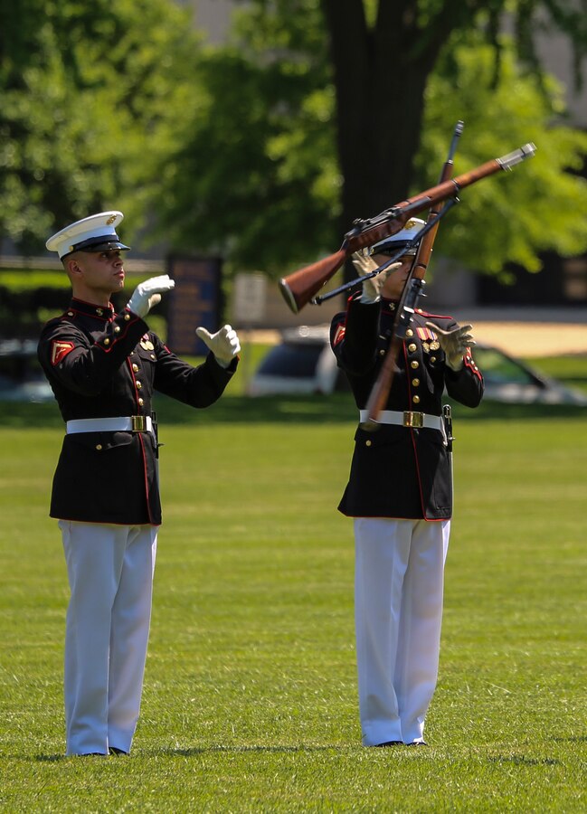 Lance Cpl. Joshua Newton, rifle inspection team, U.S. Marine Corps Silent Drill Platoon, executes precision rifle drill movements during a Battle Color Ceremony as a part of the U.S. Naval Academy Commissioning Week at the USNA, Annapolis, MD, May 21, 2018. Parents, family members and guests of the First Class Midshipmen were invited to attend a series of events, including the BCD, in honor of the graduates. (Official Marine Corps photo by Cpl. Damon Mclean/Released)