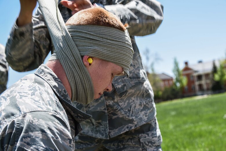 During the 90th Mission Support Group Warrior Day Airmen learned how to treat various injuries, including wrapping a head wound, May 19, 2018, on F.E. Warren Air Force Base, Wyo. Airmen also learned how to treat other injuries such as burns and broken bones, along with how to set up a landing zone in barren land. The Warrior Day was an all-day training event to reinforce deployment preparedness, warrior ethos and a commitment to teamwork. (U.S. Air Force photo by Airman 1st Class Abbigayle Wagner)