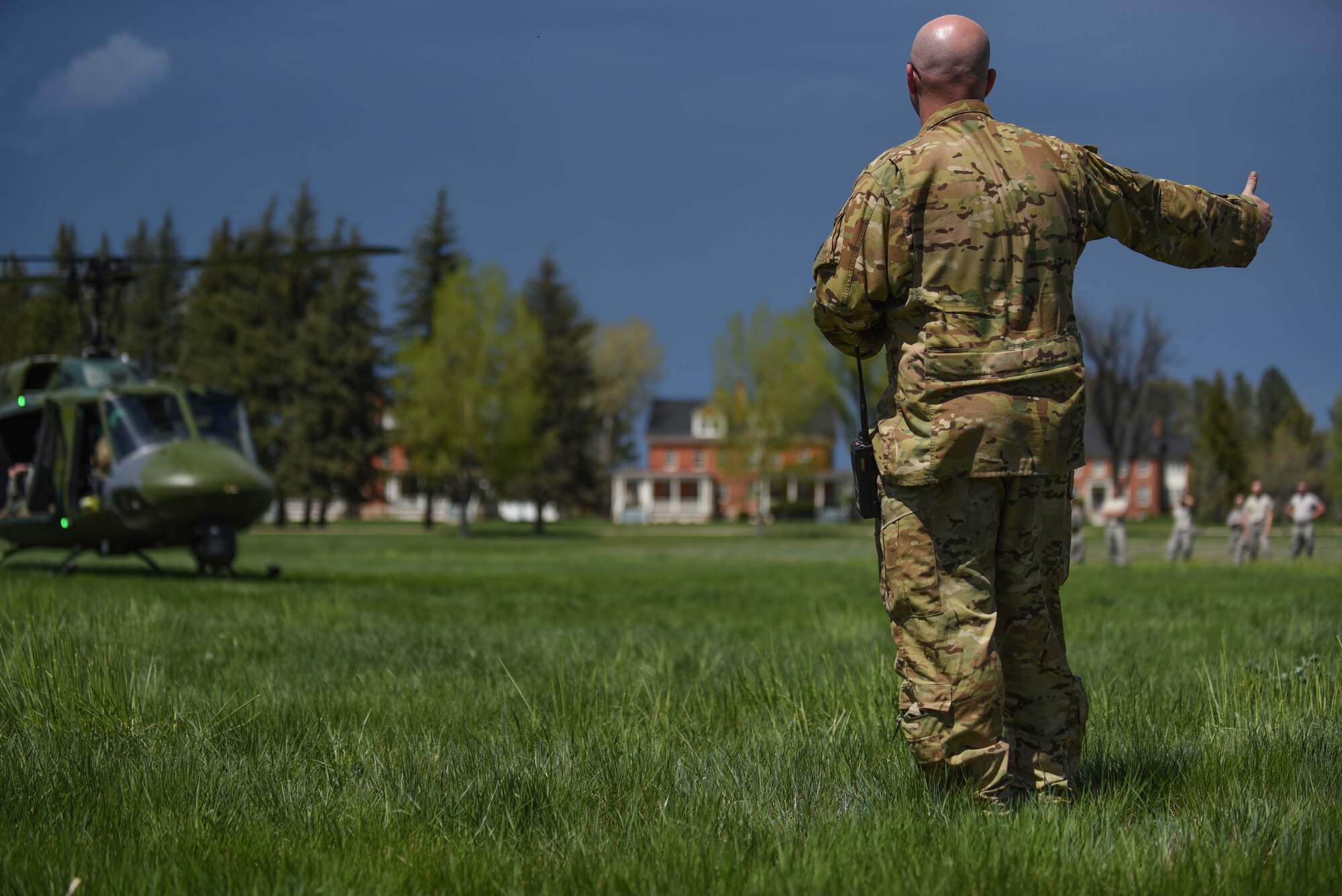 Technical Sgt. Christopher Rector, 37th Helicopter Squadron NCO in charge of plans and programs, gives a thumbs up to the helicopter pilot for takeoff, May 19, 2018, on F.E. Warren Air Force Base, Wyo. As part of the 90th Mission Support Group’s Warrior Day, Airmen received an incentive flight followed by a tour and a sample mission brief from 582nd Helicopter Group personnel. The Warrior Day was an all-day training event to reinforce deployment preparedness, warrior ethos and a commitment to teamwork. (U.S. Air Force photo by Airman 1st Class Abbigayle Wagner)