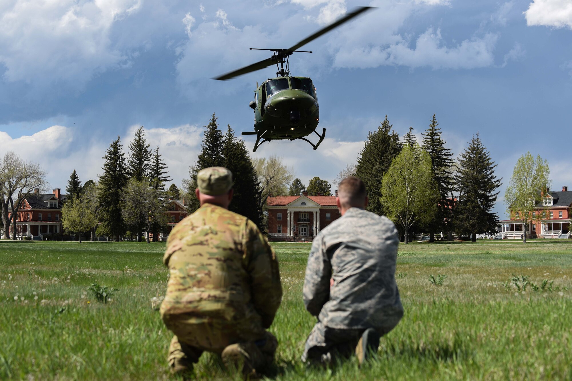 Staff Sgt. Andrew Leemasters, 790th Missile Maintenance Squadron decentralized material support technician, and Tech. Sgt. Christopher Rector, 37th Helicopter Squadron NCO in charge of plans and programs, call the helicopter into the landing zone during a 90th Mission Support Group Warrior Day, May 19, 2018, on F.E. Warren Air Force Base, Wyo. As part of the Warrior Day, Airmen participated in a casualty evacuation scenario, where they were able to practice self-aid buddy care concepts and medical evacuation procedures. The Warrior Day was an all-day training event to reinforce deployment preparedness, warrior ethos and a commitment to teamwork. (U.S. Air Force photo by Airman 1st Class Abbigayle Wagner)