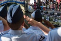 Airmen render a salute during the playing of the national anthem at the Armed Forces River Parade May 19, 2018, in San Antonio, Texas. . The Armed Forces River Parade is dedicated to the men and women of the United States Armed Forces, and features 26 patriotically-decorated floats representing all branches of military service. The theme for this year was Military City USA, in honor of the rich military history in San Antonio as San Antonio celebrates the city's tricentennial. JBSA military ambassadors represent their services at JBSA events and foster a positive relationship between the military and San Antonio community. (U.S. Air Force photo by Senior Airman Stormy Archer)