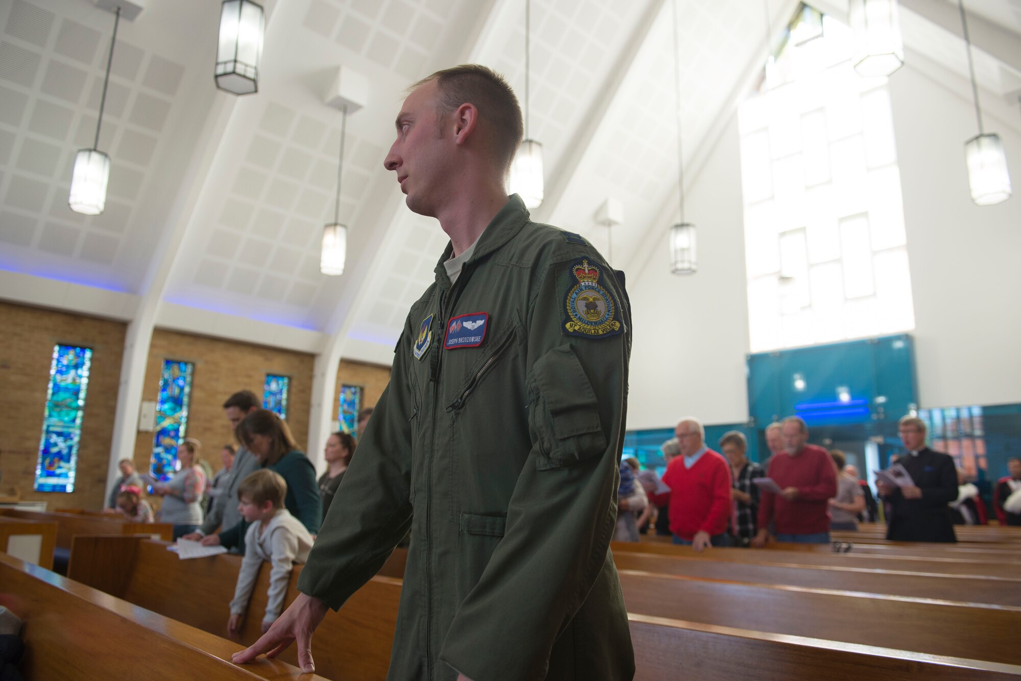 U.S. Air Force Capt Joseph Brzozowske, 100 Air Refueling Wing chief of wing readiness inspections stands for prayer during the final Catholic mass at RAF Mildenhall, England, May 14, 2018.  Those who practice the Catholic faith will still have a home at RAF Lakenheath’s chapel. (U.S. Air Force photo by Airman 1st Class Alexandria Lee)