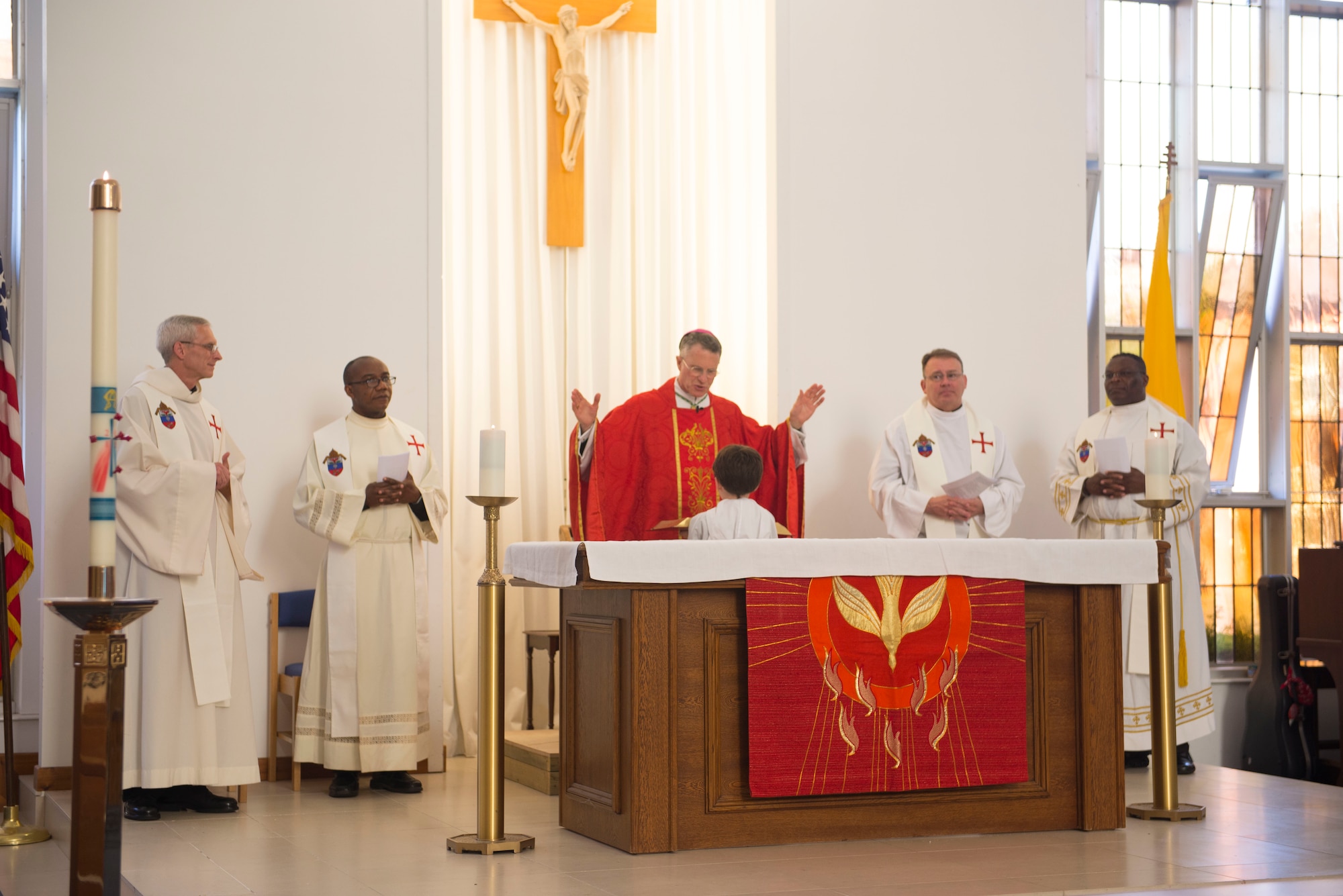 Members of the U.S.military chapel leadership stand for the reading of the Bible during the final Catholic mass at RAF Mildenhall, England, May 14, 2018. The Catholic Parish falls under Our Lady of Walsingham Catholic Community, and has been a part of RAF Mildenhall since 1955. (U.S. Air Force photo by Airman 1st Class Alexandria Lee)