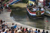 Lt. Gen. Jeffrey S. Buchanan, Army North commander, rides on a float representing the U.S. Army during the Armed Forces River Parade May 19, 2018, in San Antonio, Texas. . The Armed Forces River Parade is dedicated to the men and women of the United States Armed Forces, and features 26 patriotically-decorated floats representing all branches of military service. The theme for this year was Military City USA, in honor of the rich military history in San Antonio as San Antonio celebrates the city's tricentennial. JBSA military ambassadors represent their services at JBSA events and foster a positive relationship between the military and San Antonio community. (U.S. Air Force photo by Senior Airman Stormy Archer)