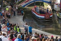 Members of the U.S. Marine Corps take part in the Armed Forces River Parade May 19, 2018, in San Antonio, Texas. . The Armed Forces River Parade is dedicated to the men and women of the United States Armed Forces, and features 26 patriotically-decorated floats representing all branches of military service. The theme for this year was Military City USA, in honor of the rich military history in San Antonio as San Antonio celebrates the city's tricentennial. JBSA military ambassadors represent their services at JBSA events and foster a positive relationship between the military and San Antonio community. (U.S. Air Force photo by Senior Airman Stormy Archer)
