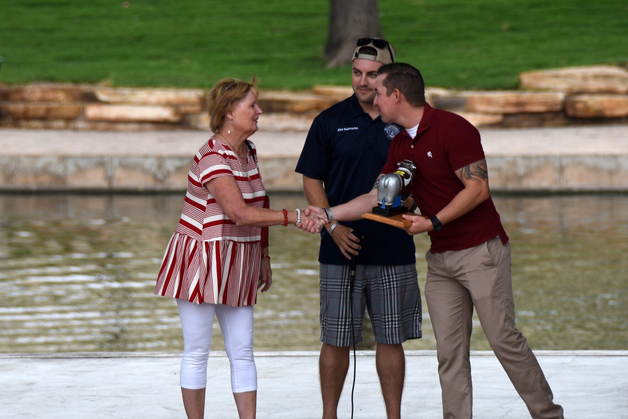 U.S. Air Force Tech. Sgt. Louis Erk, 315th Training Squadron instructor supervisor, receives the Phil Neighbors Community Impact award for volunteer work in San Angelo during the Goodfellow Appreciation Day at the Bill Aylor Sr. Memorial RiverStage in San Angelo, Texas, May 19, 2018. Erk helped create a Science Technology Engineering and Math program for children, kindergarten through 5th grade, in the community. (U.S. Air Force photo by Airman 1st Class Zachary Chapman/Released)