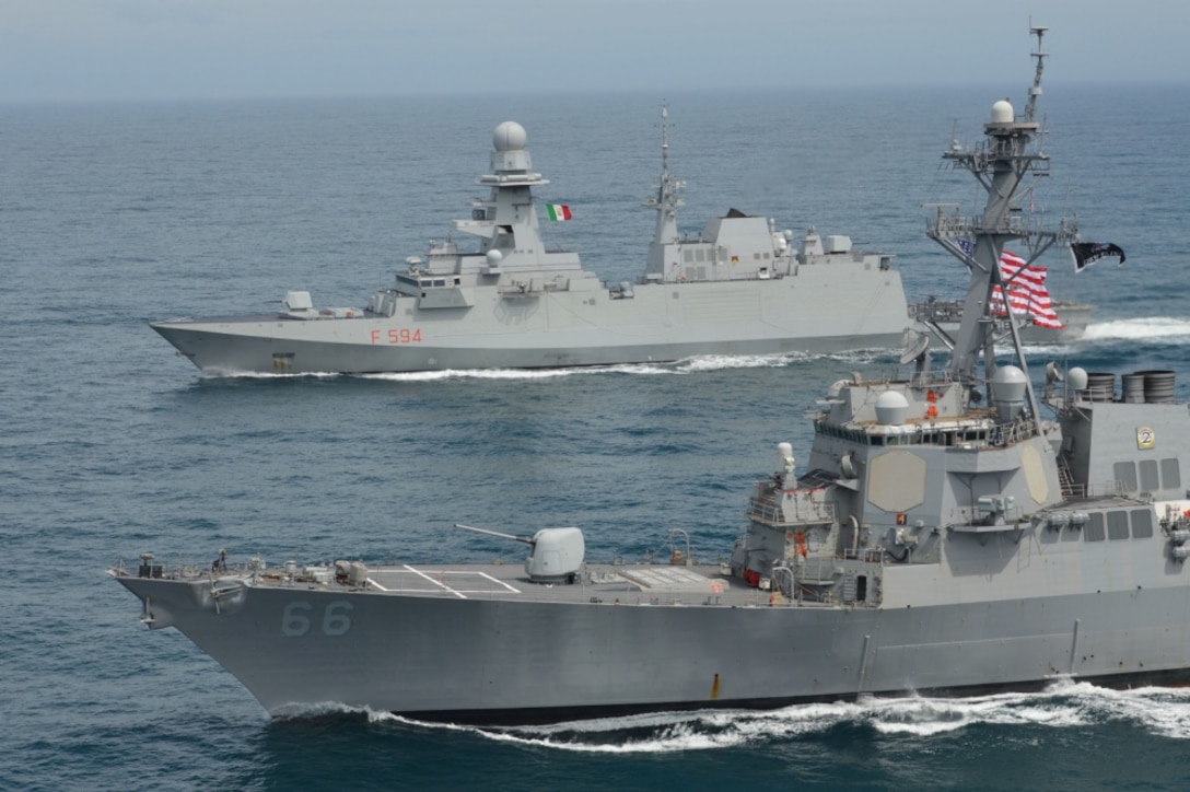 The guided-missile destroyer USS Gonzalez conducts a passing exercise with the Italian multimission frigate ITS Alpino in the Atlantic Ocean.