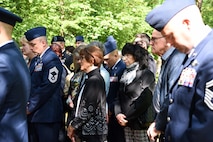 Civilians and military members bow their heads for prayer during the Kindergraves Memorial at Kaiserslautern Main Cemetery May 19, 2018. Participants prayed individually after being led in prayer by two different chaplains.