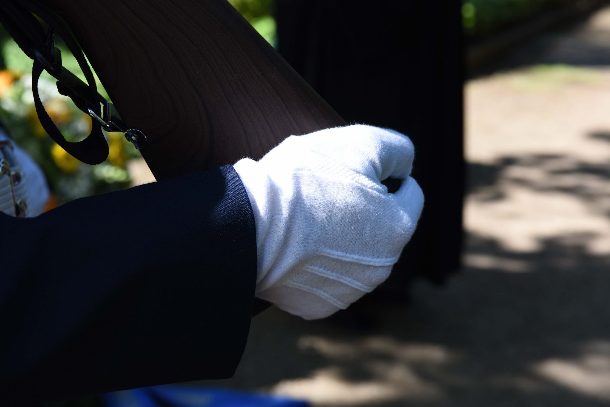 A Ramstein High Cchool Jr. Reserve Officer Training Corps member holds a rifle during the wreath laying ceremony at Kaiserslautern Main Cemetery May, 19, 2018. Ramstein’s JROTC presented the colors for each national anthem and led the march to the gravesite.