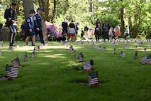 Civilians and military members pay respects to the 458 infants in the kindergraves, at Kaiserslautern Main Cemetery May 19, 2018. Although there are 458 infants laid to rest at the cemetery, there are only 452 burial plots.