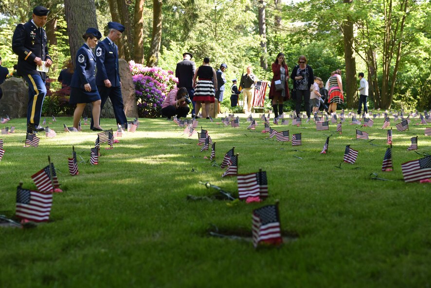 Civilians and military members pay respects to the 458 infants in the kindergraves, at Kaiserslautern Main Cemetery May 19, 2018. Although there are 458 infants laid to rest at the cemetery, there are only 452 burial plots.