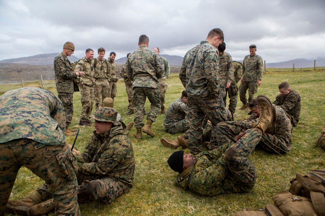 Marines with 4th Air Naval Gunfire Liaison Company, Force Headquarters Group, utilize new escape techniques during survival training, in Durness, Scotland, April 26, 2018.
