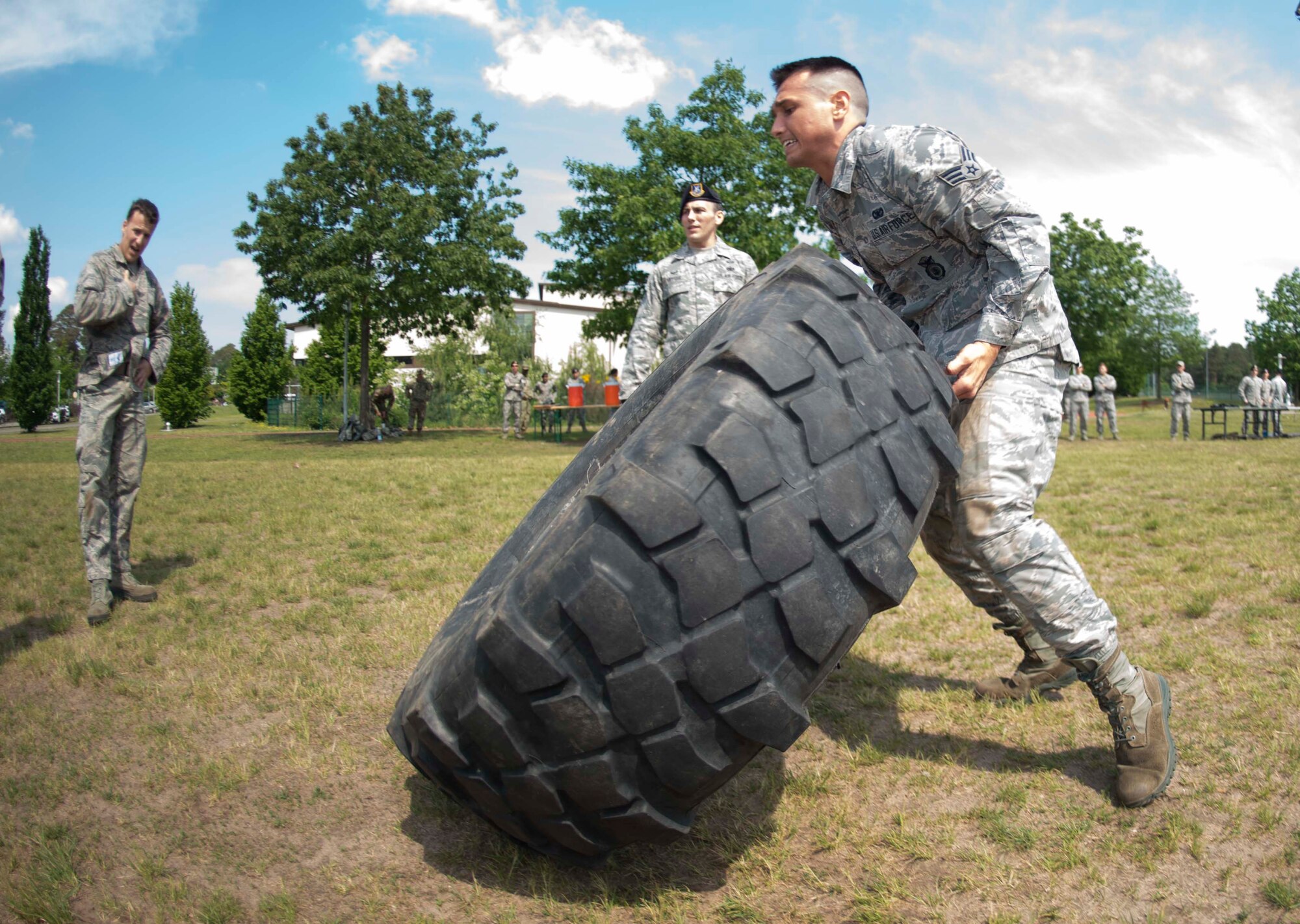 A U.S. Airman flips a tire during the Police Week 2018 Battle of the Badges competition on Ramstein Air Base, Germany, May 15, 2018. Eight law enforcement units, including the 86th Security forces Squadron, the 569th U.S. Forces Police Squadron, and the 435th Contingency Response Group, competed against each other in tests of strength, endurance, and weapons handling. (U.S. Air Force photo by Senior Airman Elizabeth Baker)