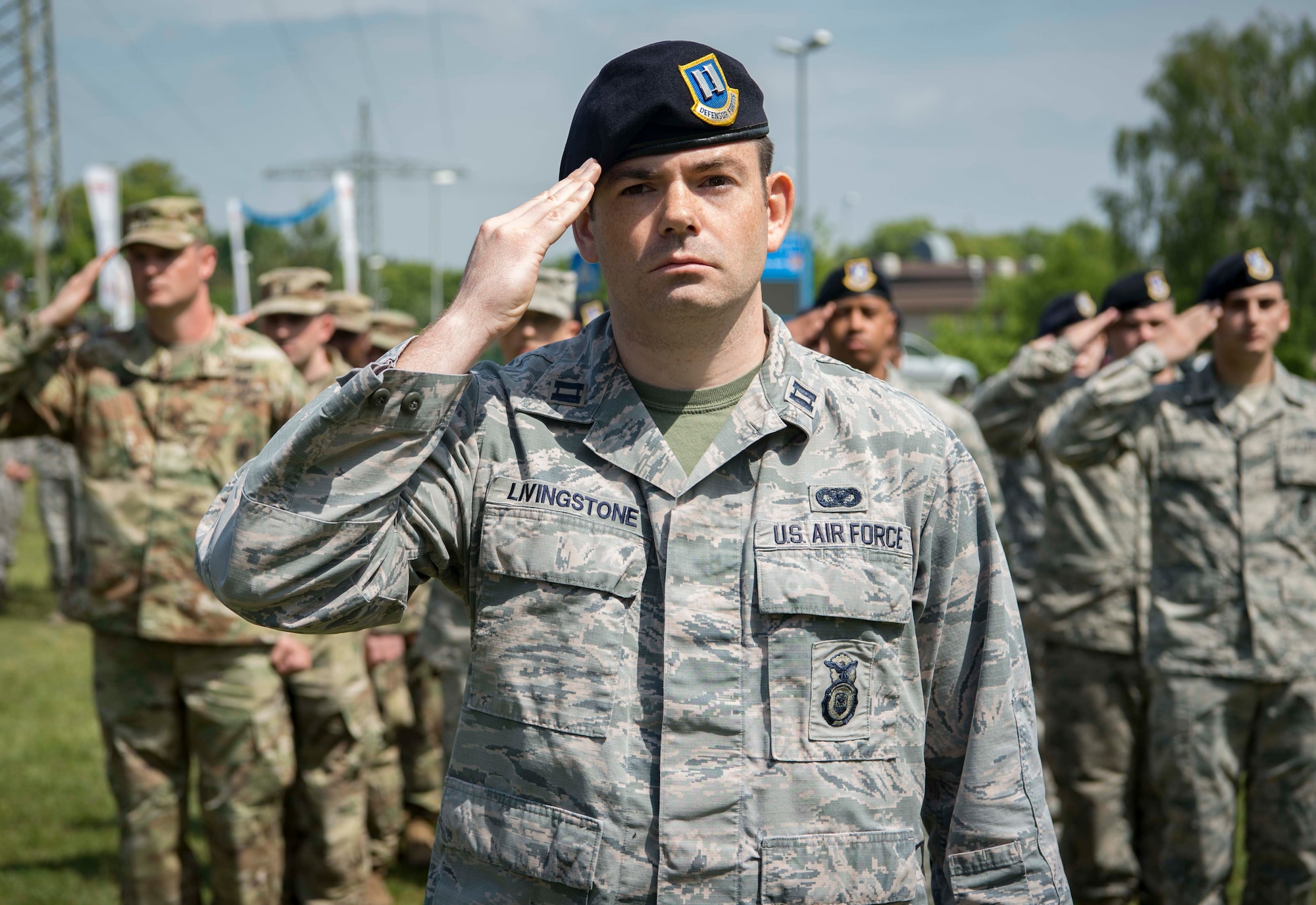 U.S. Airmen render salute as an American flag lowers during a retreat ceremony as part of Police Week 2018 on Vogelweh Air Station, Germany, May 18, 2018. The Kaiserslautern Military Community U.S. armed forces police services perform a retreat ceremony every year during Police Week to remember and honor fallen members of the police services brotherhood. (U.S. Air Forces photo by Senior Airman Elizabeth Baker)