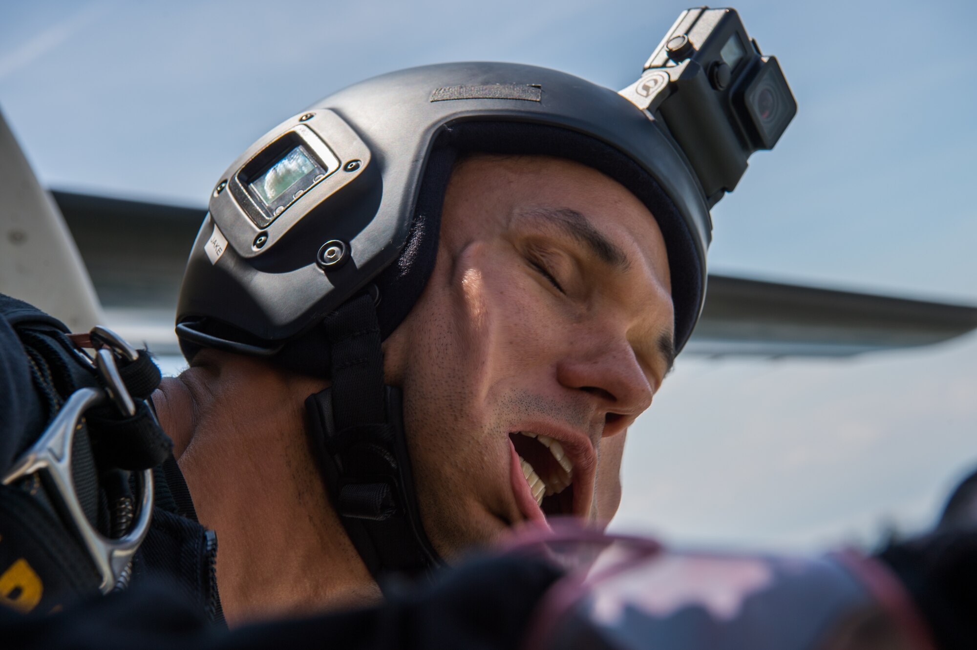 U.S. Army Staff Sgt. Jacob Kerkow, Golden Knights gold demonstration team drop zone safety officer and field medic, sticks his head out of the aircraft before jumping at Joint Base Langley-Eustis, Va., May 20, 2018.