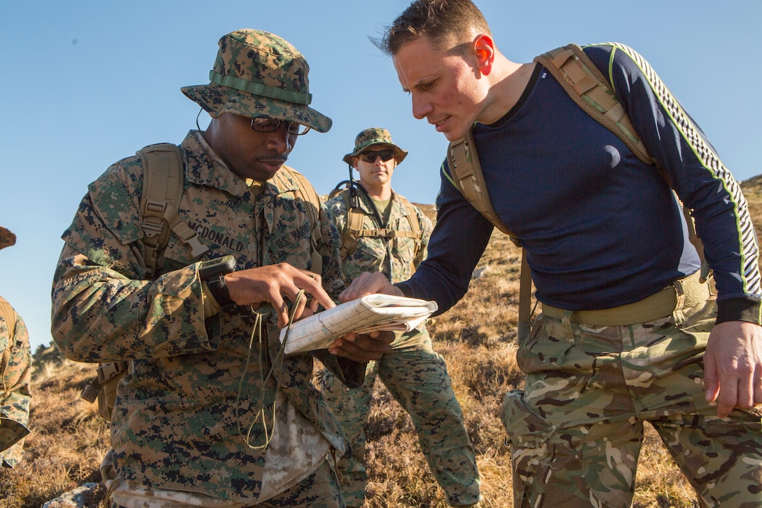 U.S. Marine Corps Lance Cpl. Gregory McDonald (left), a radio operator with 4th Air Naval Gunfire Liaison Company, Force Headquarters Group, and Royal Navy Chief Petty Officer Andrew Douglas (right), a Royal Navy coordinator with 148 Commando Battery, 29th Commando Royal Artillery, discuss route options for a checkpoint during a land navigation exercise in Durness, Scotland, April 30, 2018.