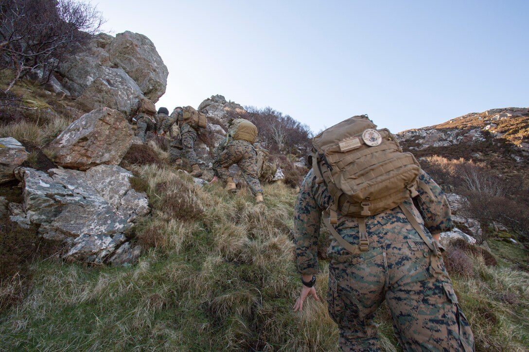 Marines and sailors with 4th Air Naval Gunfire Liaison Company, Force Headquarters Group, scale a mountain to get to their second checkpoint during a land navigation exercise in Durness, Scotland, April 30, 2018.