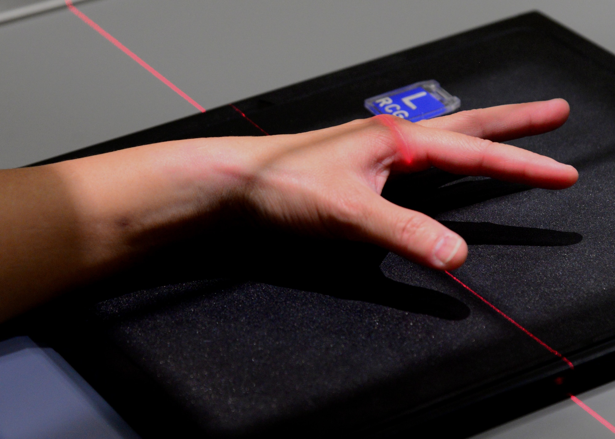 Master Sgt. Mia Newmeyer, 28th Medical Support Squadron diagnostic imaging noncommissioned officer in charge, places her hand underneath an X-ray machine inside the 28th Medical Group at Ellsworth Air Force Base, S.D., May 11, 2018. Diagnostic imaging provides basic skeletal exams to include the skull and extremities. (U.S. Air Force photo by Senior Airman Denise Jenson)