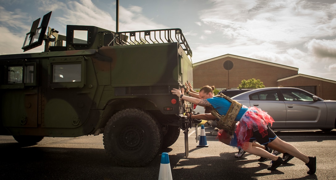 The 633rd Medical Support Squadron team pushes a humvee during the National Police Week Defenders’ Challenge at Joint Base Langley-Eustis, Virginia, May 16, 2018.