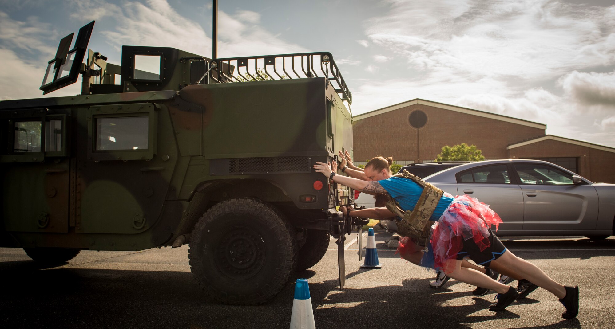 The 633rd Medical Support Squadron team pushes a humvee during the National Police Week Defenders’ Challenge at Joint Base Langley-Eustis, Virginia, May 16, 2018.