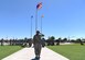 Security Forces members salute during official ceremony.